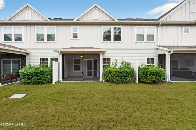 a front view of a house with a garden and yard