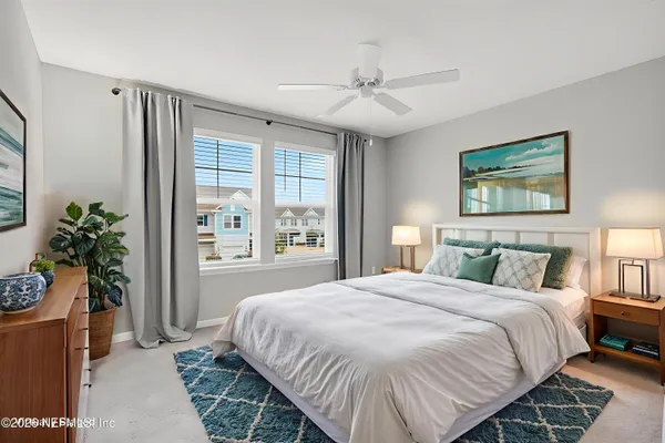 a bedroom with a large bed and a window