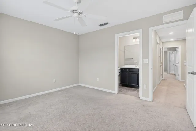 an empty room with a bathroom and a sink