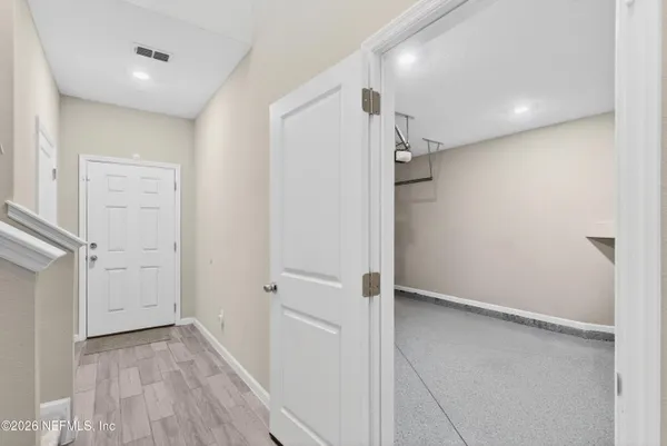 a view of a hallway with wooden floor