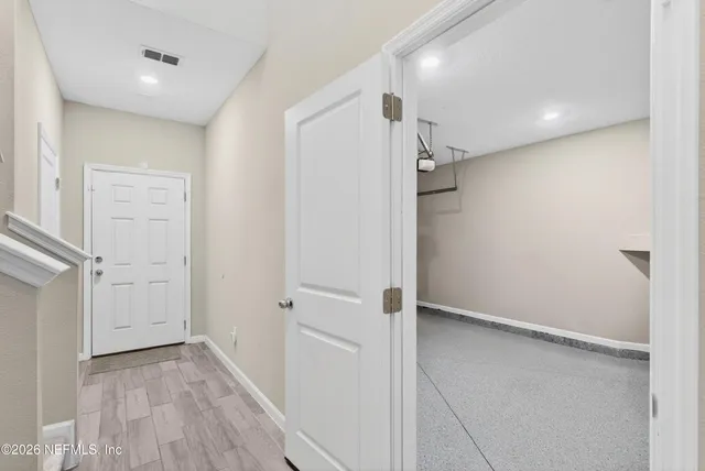 a view of a hallway with wooden floor