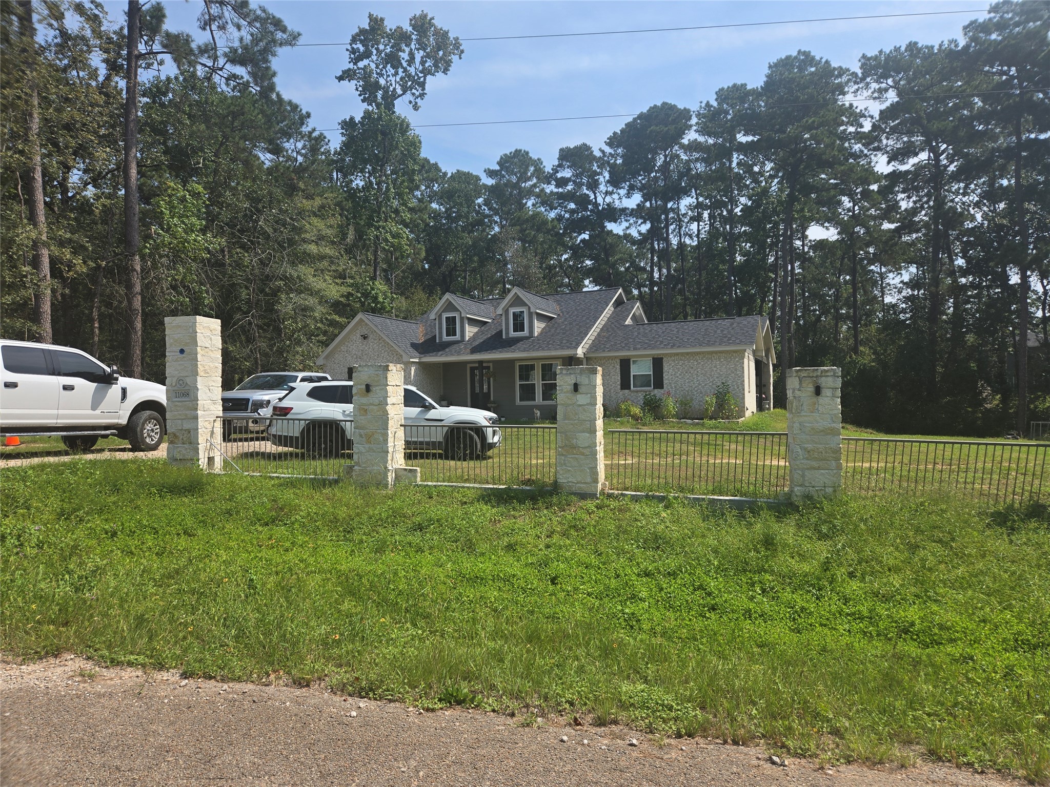 0 Berry Lane Conroe, TX 77302 - Photo 5 of 6 a front view of a house with a yard