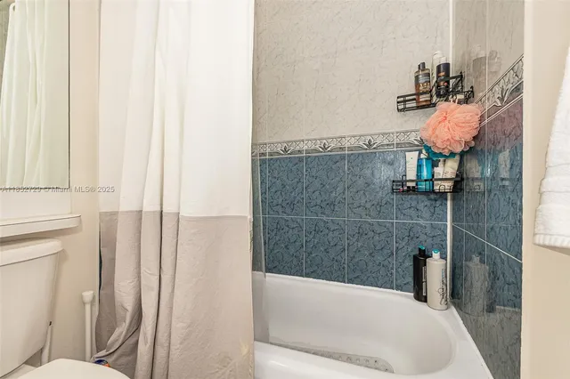 a view of a chairs and table in the backyard