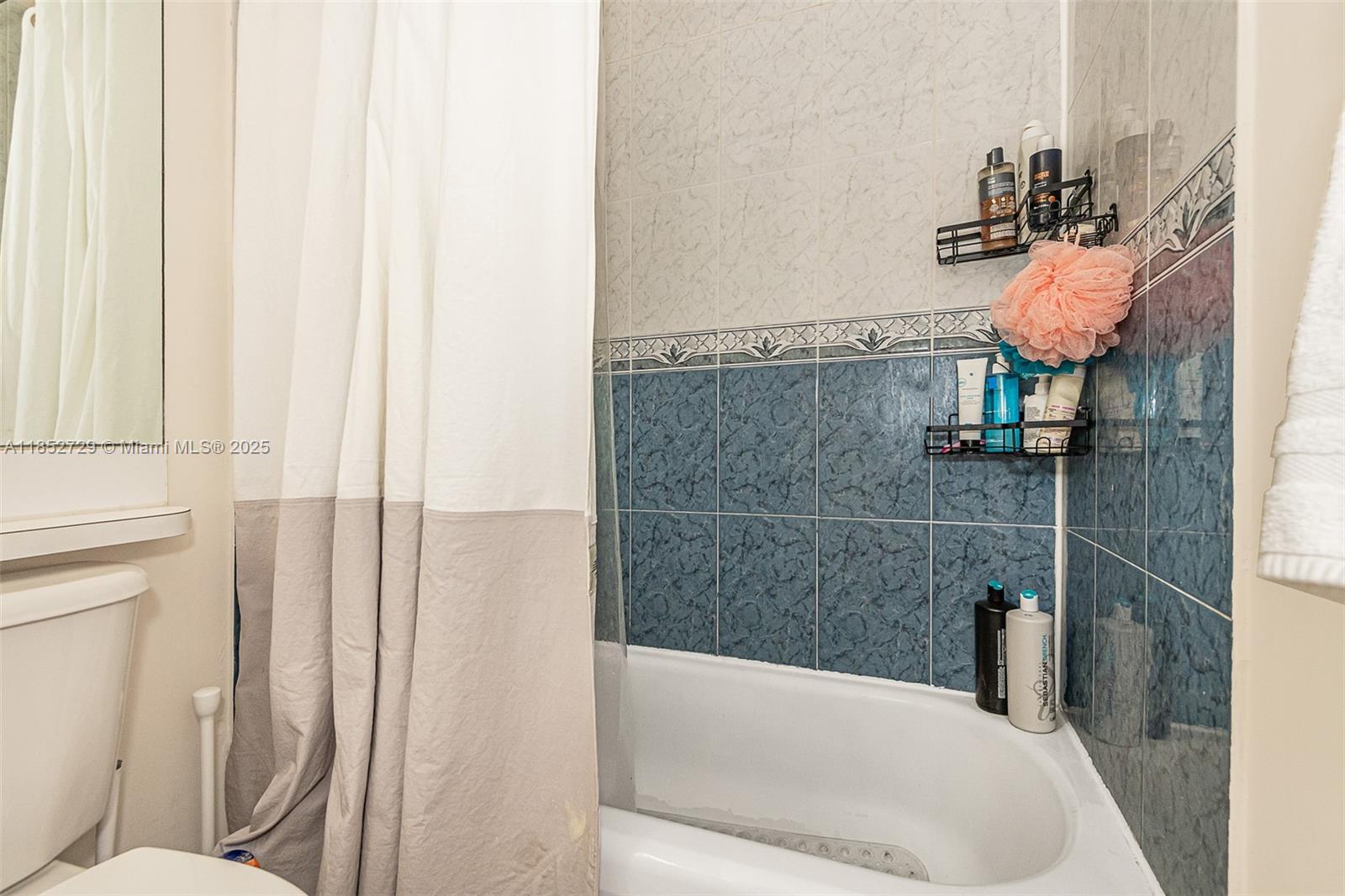 2734 Bird Avenue, Unit 107 Miami, FL 33133 - Photo 11 of 15 a bathroom with a bathtub and sink