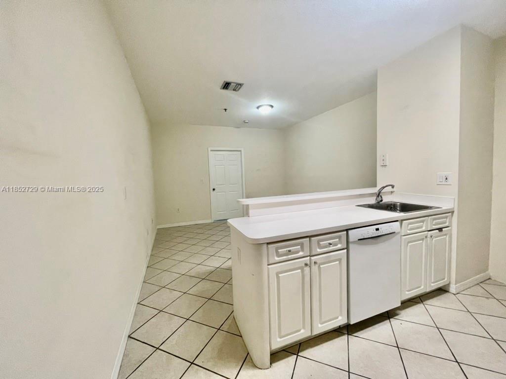 2734 Bird Avenue, Unit 107 Miami, FL 33133 - Photo 2 of 15 a view of a kitchen with white cabinets