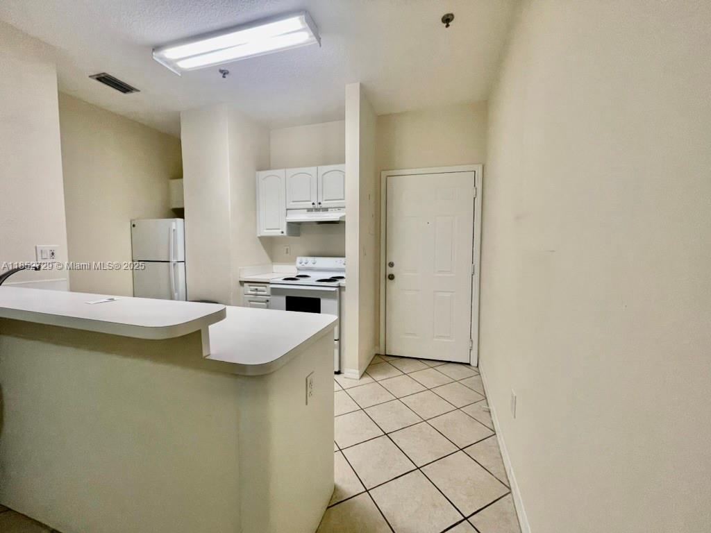 2734 Bird Avenue, Unit 107 Miami, FL 33133 - Photo 3 of 15 a view of kitchen with furniture and refrigerator