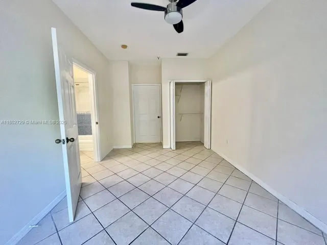 a view of kitchen with granite countertop cabinets and sink