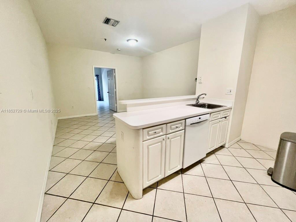 2734 Bird Avenue, Unit 107 Miami, FL 33133 - Photo 9 of 15 a kitchen with stainless steel appliances granite countertop a sink and cabinets
