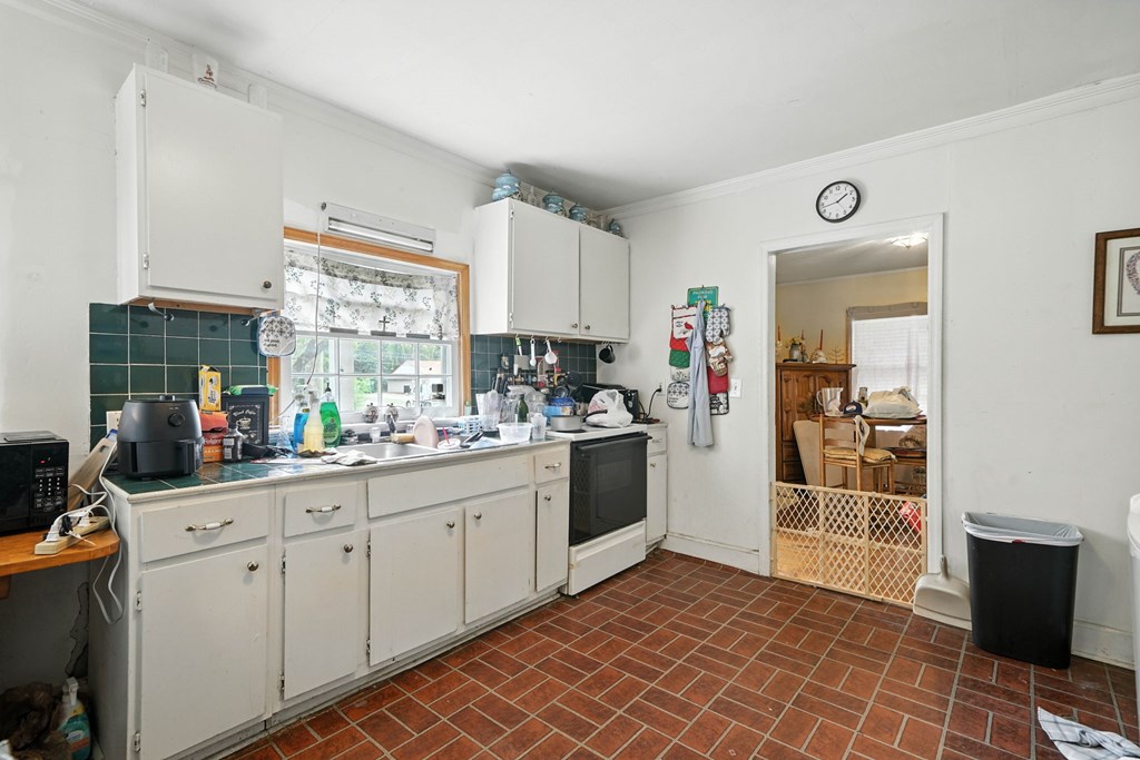 1003 East Church Street Jasper, GA 30143 - Photo 14 of 27 a kitchen with a sink cabinets and window