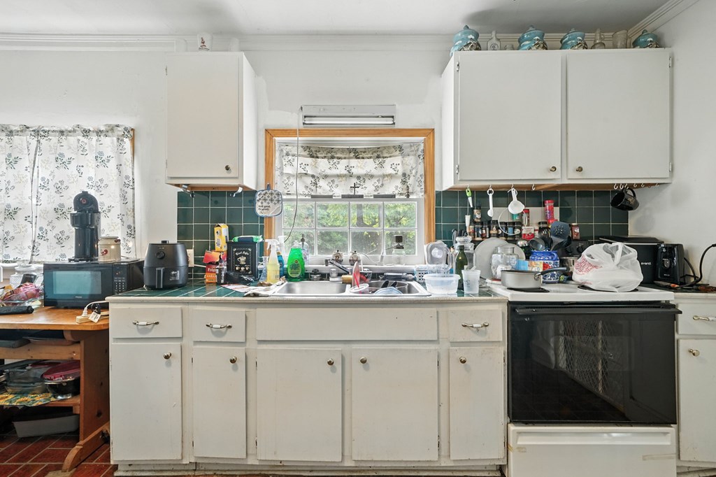 1003 East Church Street Jasper, GA 30143 - Photo 15 of 27 a kitchen with granite countertop white cabinets and white appliances