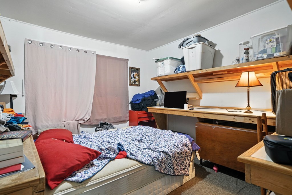 1003 East Church Street Jasper, GA 30143 - Photo 19 of 27 a bedroom with a bed and dresser