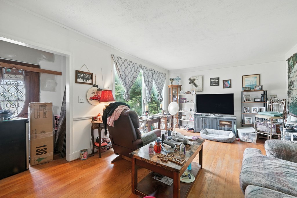 1003 East Church Street Jasper, GA 30143 - Photo 9 of 27 a living room with furniture a flat screen tv and a table