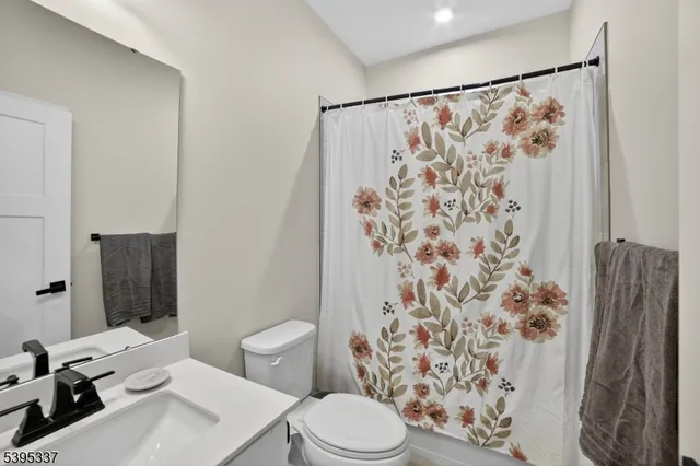 a white toilet sitting next to a bathroom sink