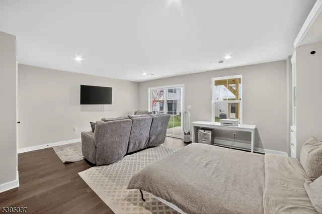 a bedroom with furniture and a flat screen tv
