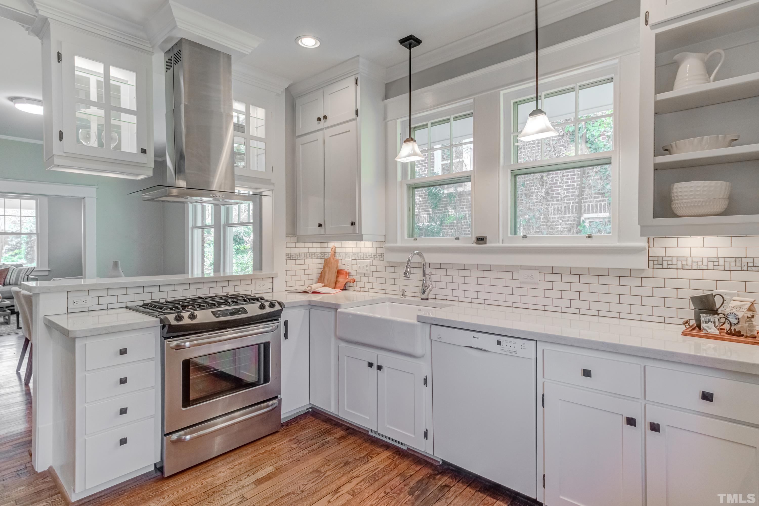 402 Cole Street Raleigh, NC 27605 - Photo 11 of 39 a kitchen with stainless steel appliances white cabinets and a stove