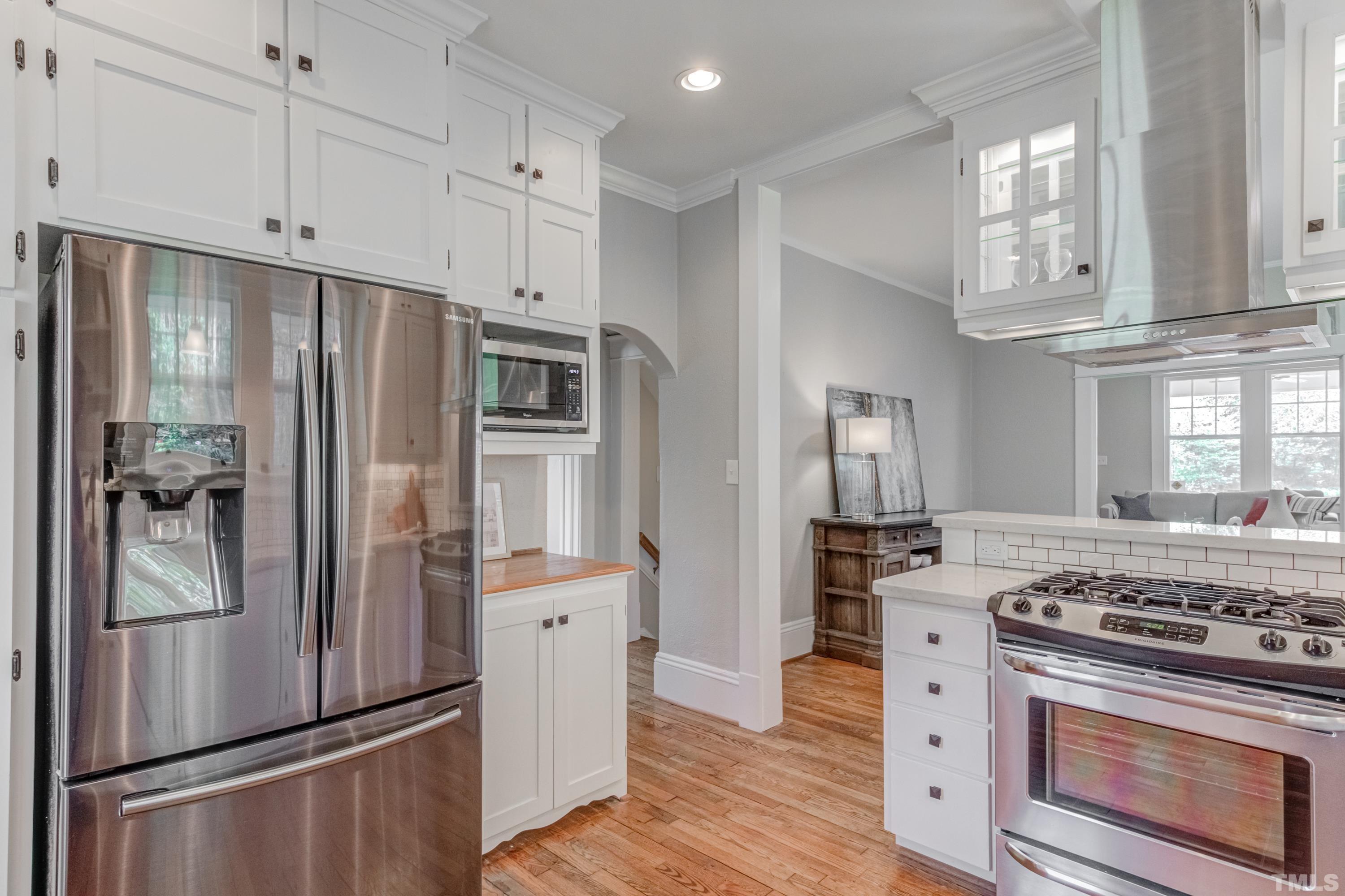 402 Cole Street Raleigh, NC 27605 - Photo 12 of 39 a kitchen with stainless steel appliances granite countertop a refrigerator stove and sink