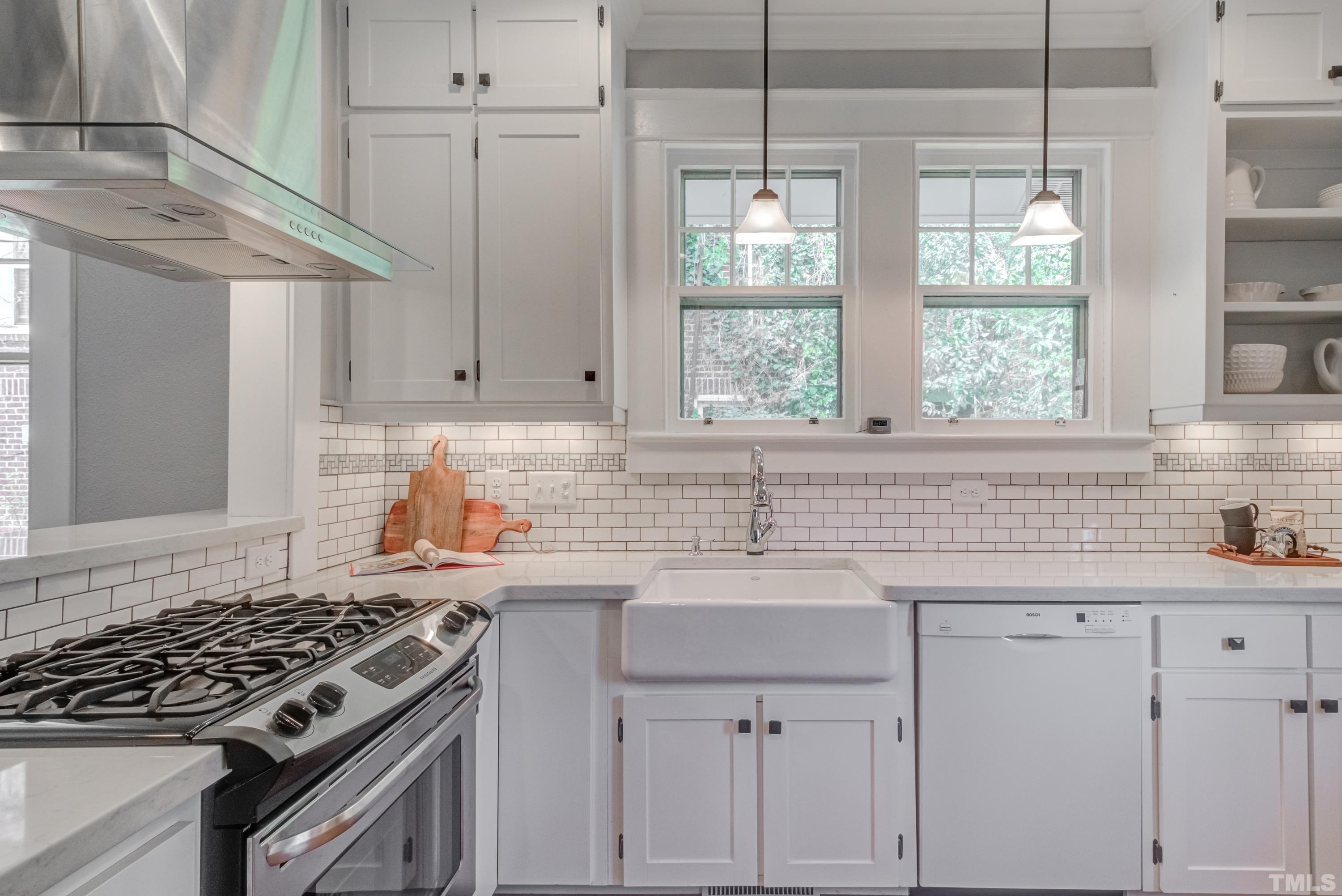402 Cole Street Raleigh, NC 27605 - Photo 15 of 39 a kitchen with a sink stove and cabinets