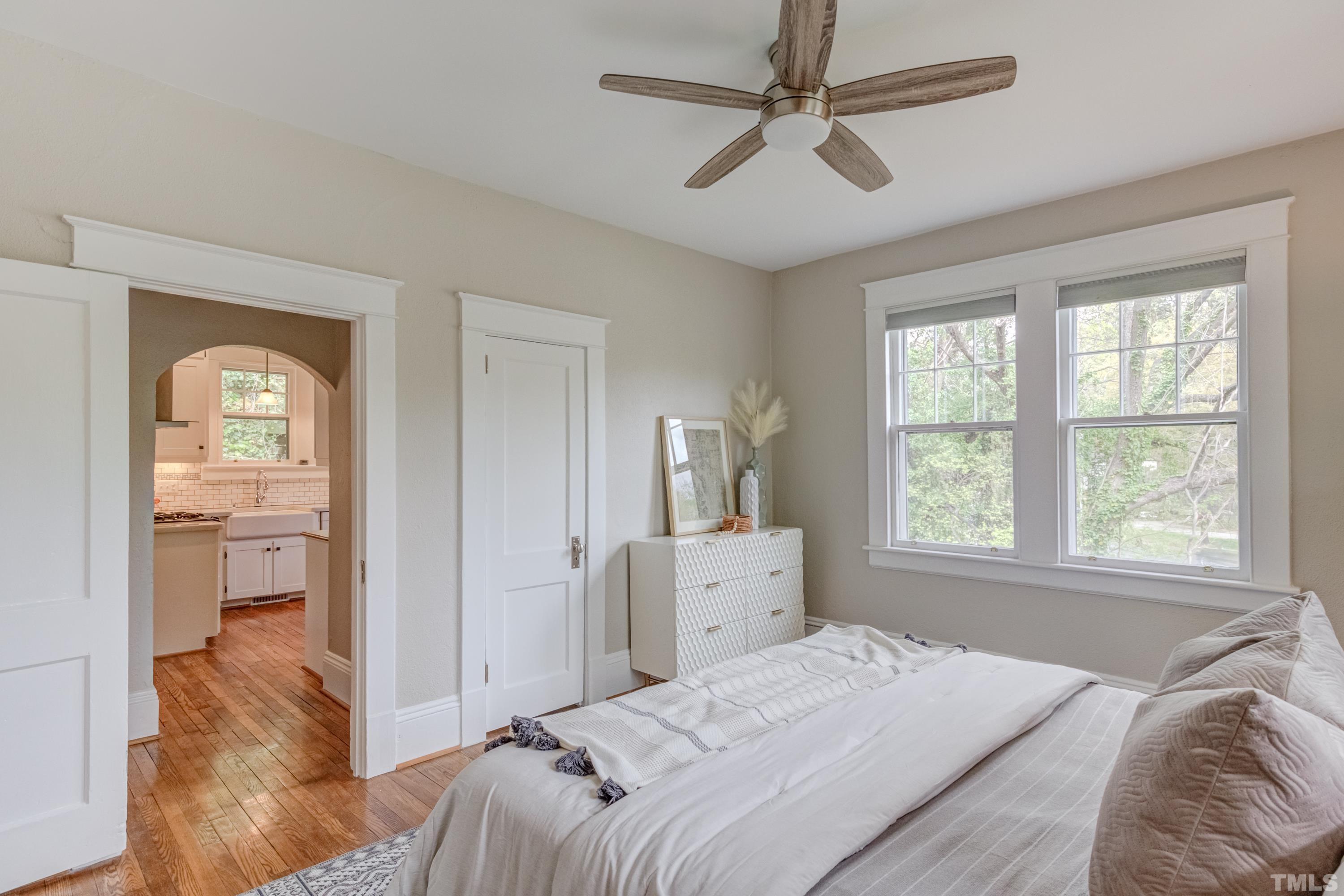 402 Cole Street Raleigh, NC 27605 - Photo 17 of 39 a bedroom with a bed and a chandelier