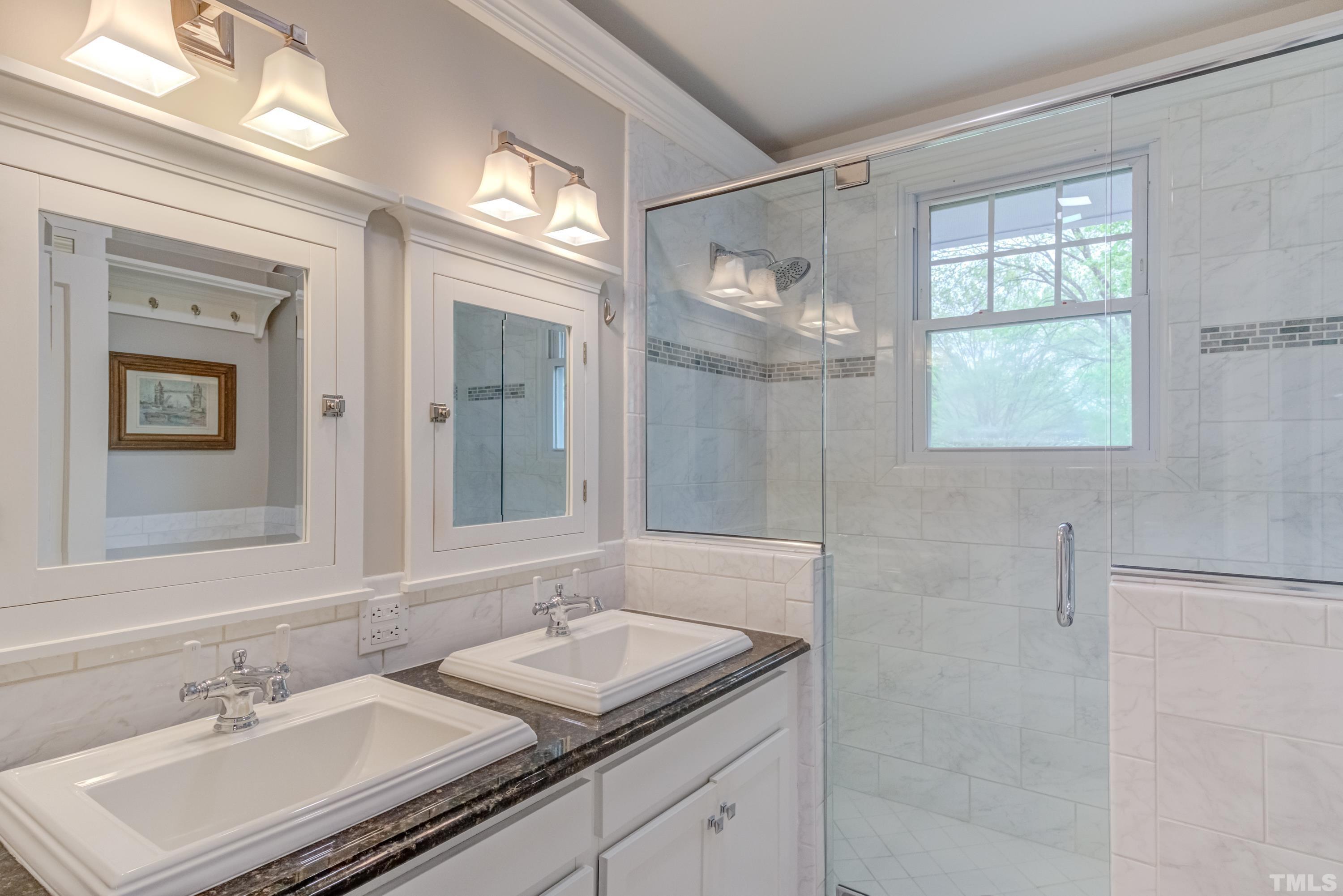 402 Cole Street Raleigh, NC 27605 - Photo 19 of 39 a bathroom with 2 sink and a mirror
