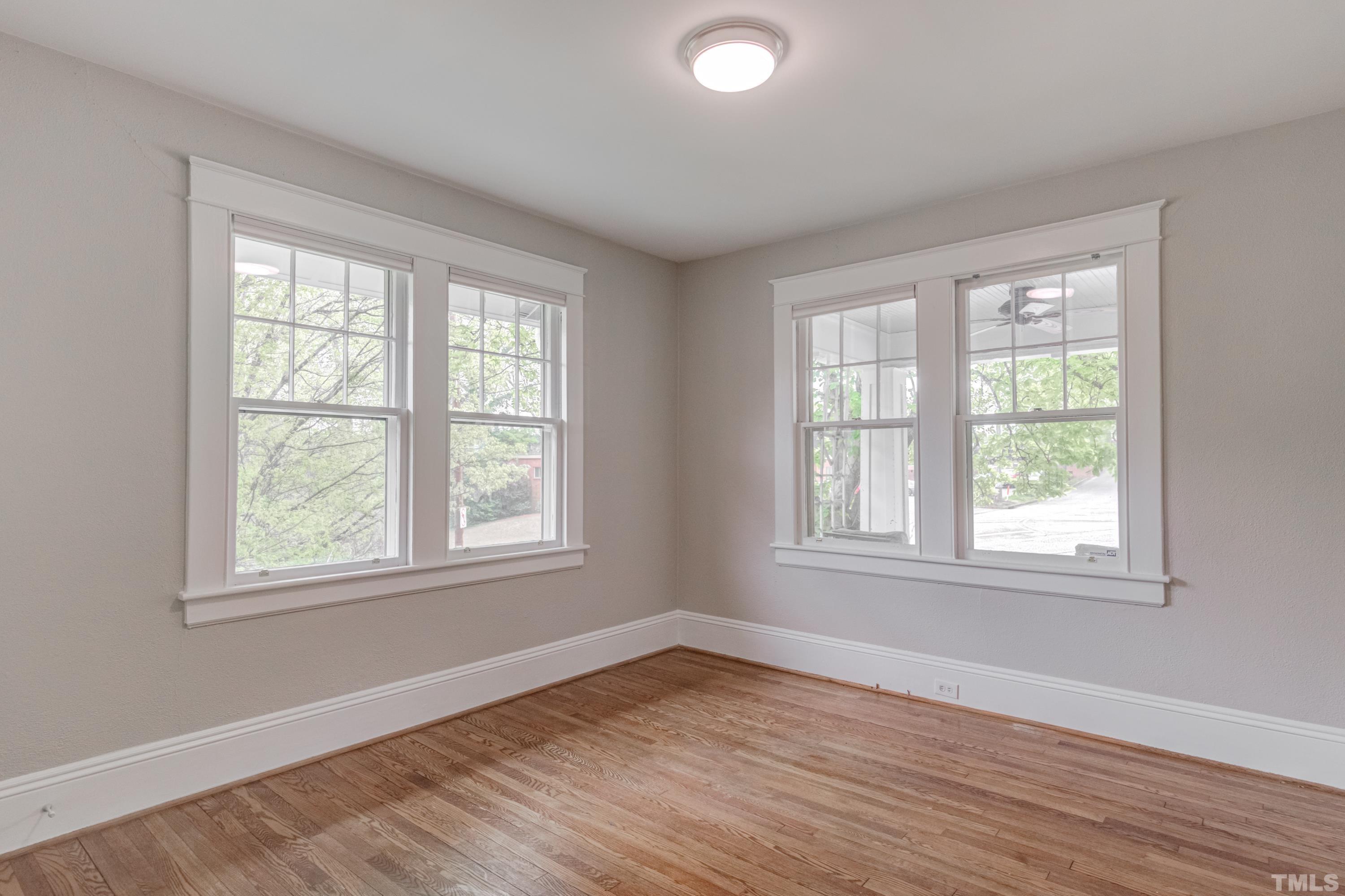 402 Cole Street Raleigh, NC 27605 - Photo 20 of 39 an empty room with wooden floor and windows