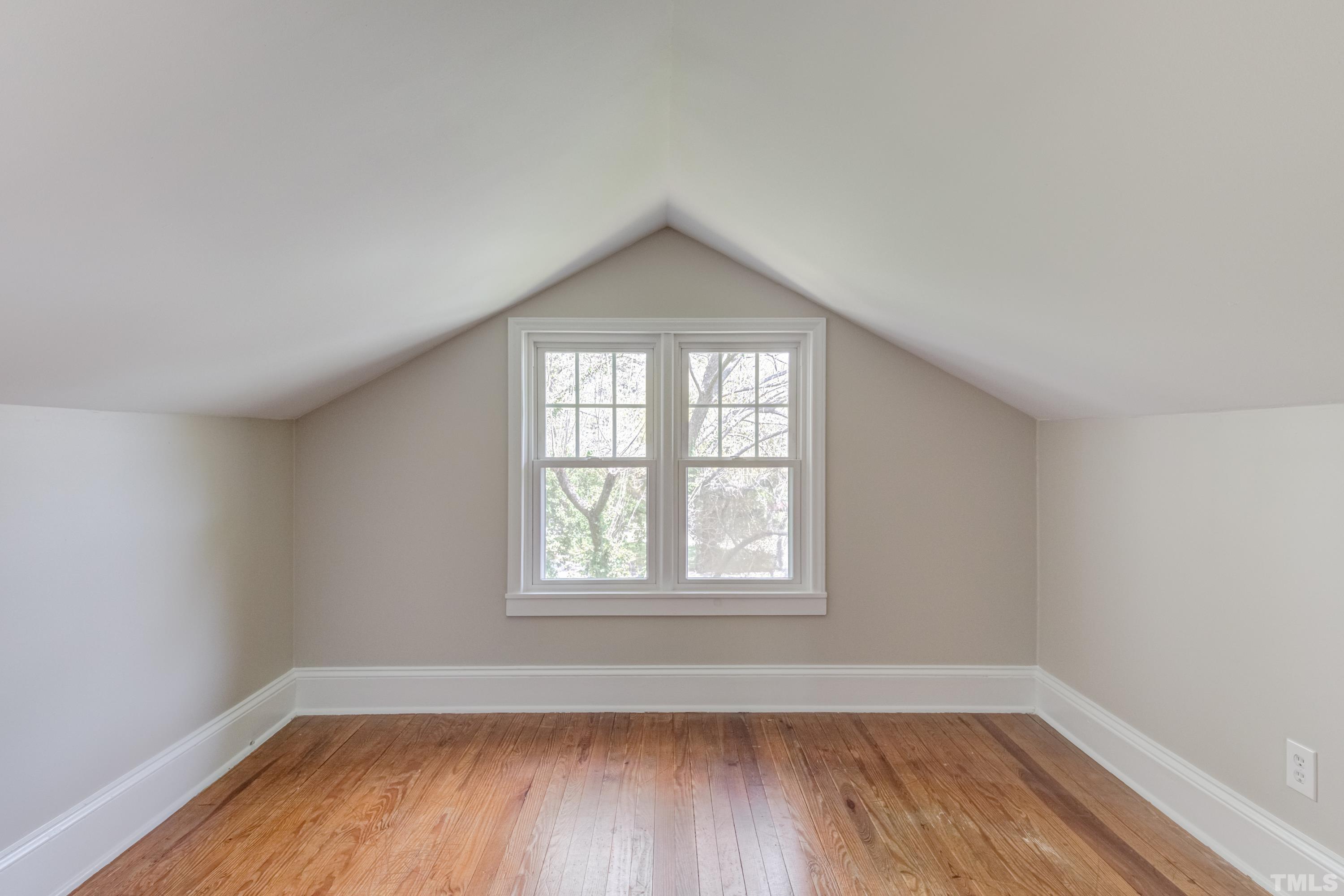 402 Cole Street Raleigh, NC 27605 - Photo 23 of 39 an empty room with wooden floor and windows
