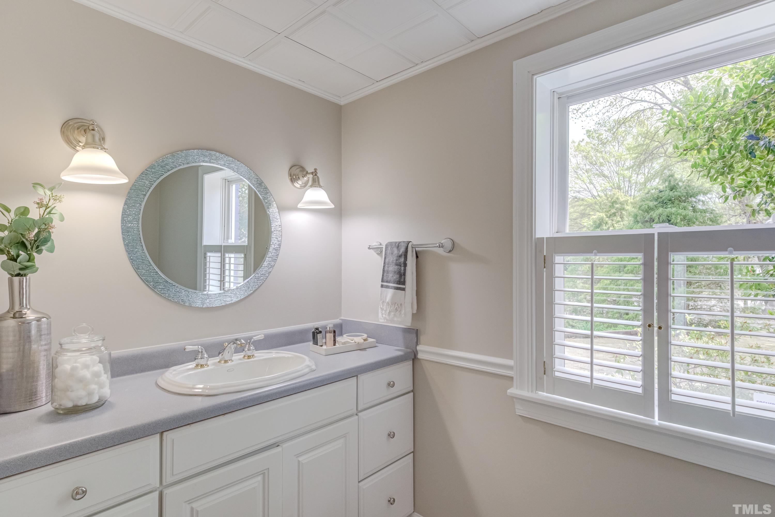 402 Cole Street Raleigh, NC 27605 - Photo 30 of 39 a bathroom with a granite countertop sink and a mirror