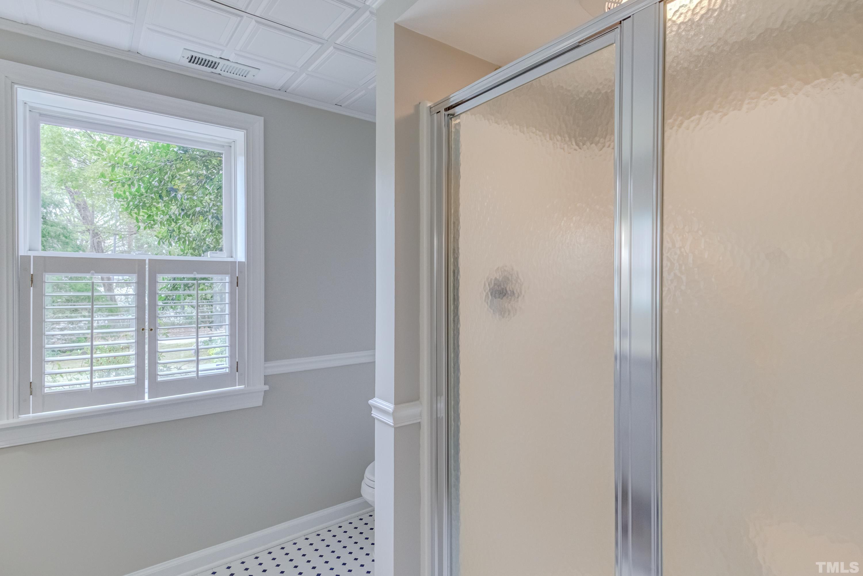 402 Cole Street Raleigh, NC 27605 - Photo 31 of 39 a bathroom with a shower and a window