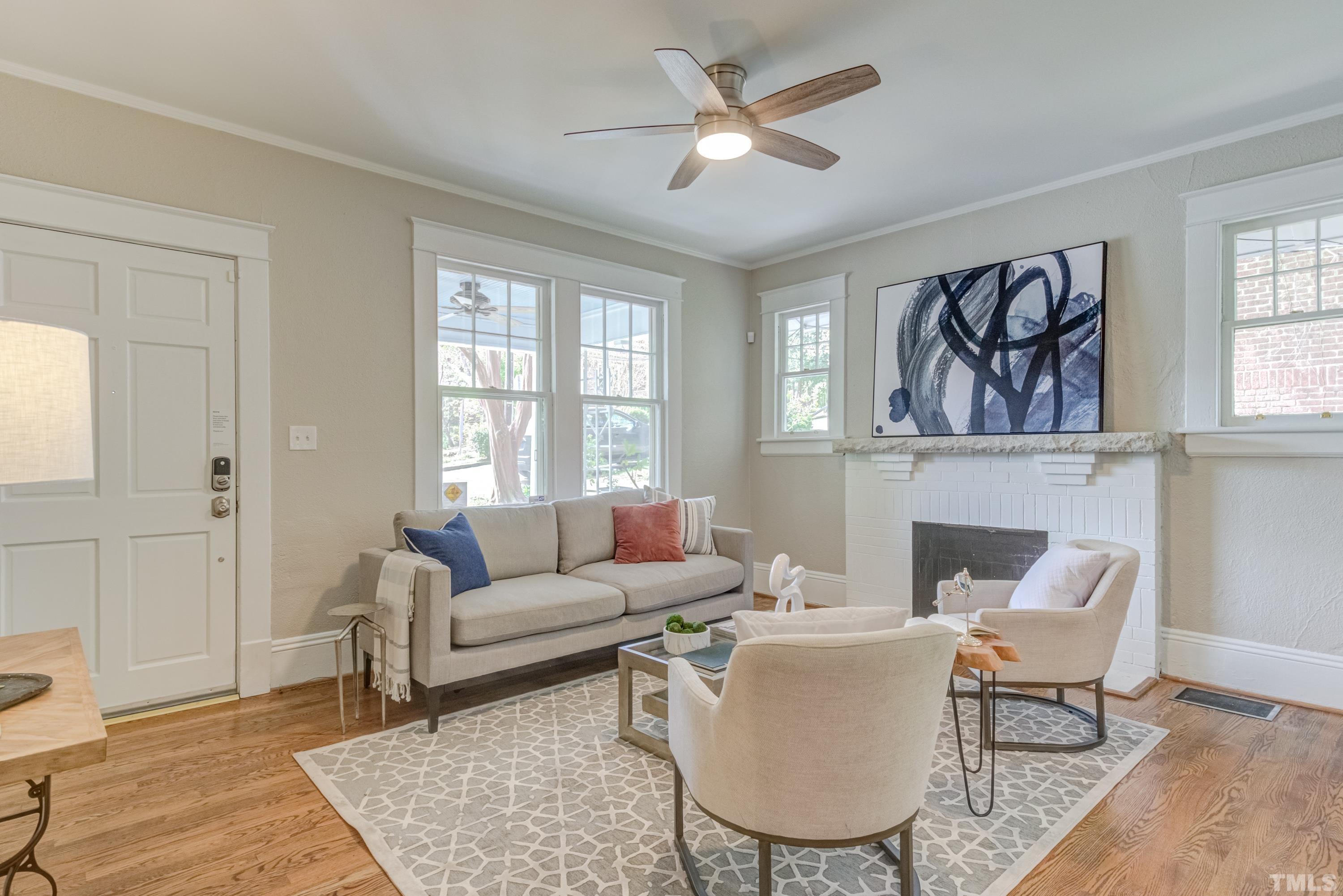 402 Cole Street Raleigh, NC 27605 - Photo 4 of 39 a living room with furniture a fireplace and wooden floor