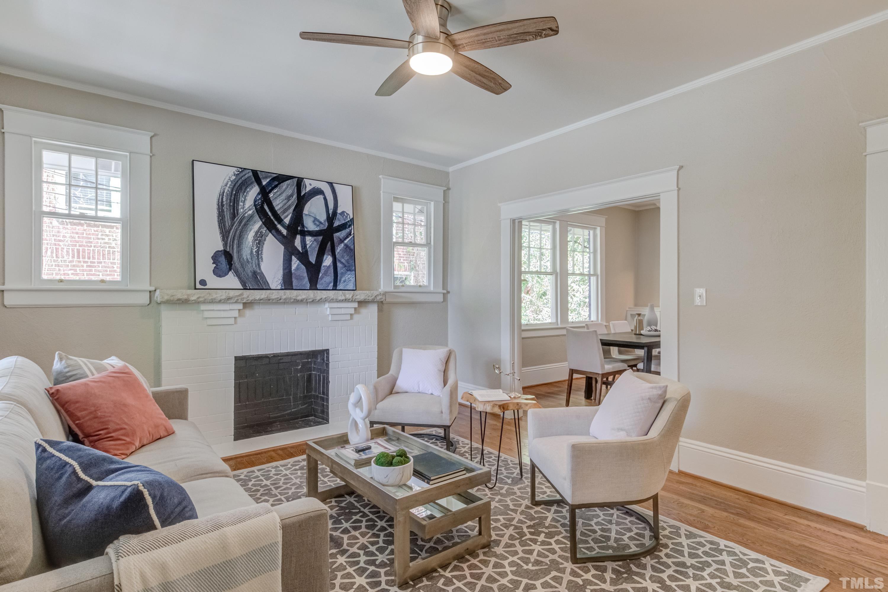 402 Cole Street Raleigh, NC 27605 - Photo 6 of 39 a living room with furniture two windows and a fireplace