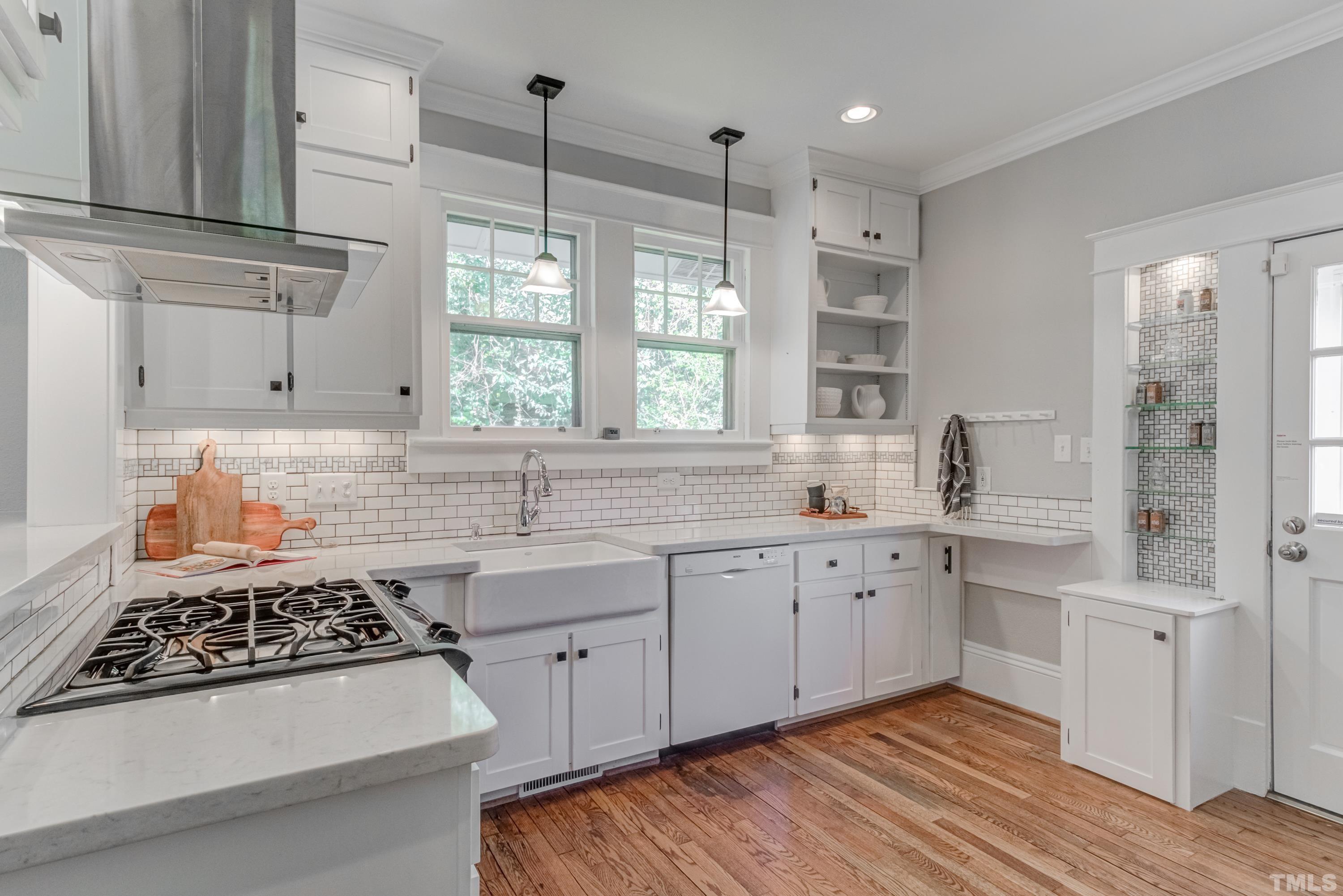 402 Cole Street Raleigh, NC 27605 - Photo 10 of 39 a kitchen with granite countertop a sink stove and cabinets