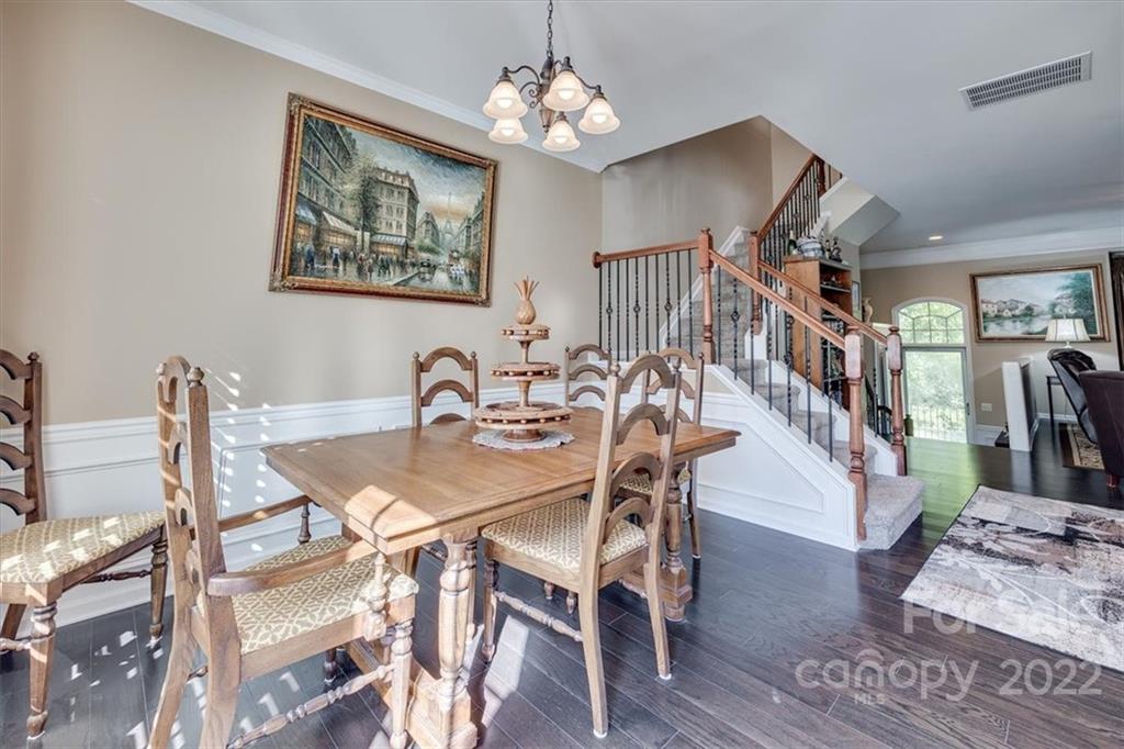 1112 Drayton Court Fort Mill, SC 29708 - Photo 11 of 27 a view of a dining room with furniture wooden floor and a chandelier