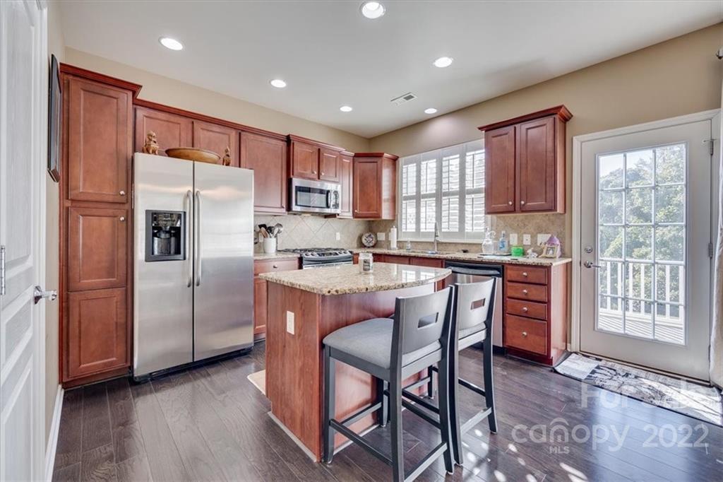 1112 Drayton Court Fort Mill, SC 29708 - Photo 12 of 27 a kitchen with stainless steel appliances granite countertop a refrigerator a sink a stove a dining table and chairs