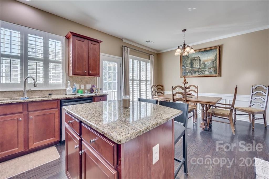 1112 Drayton Court Fort Mill, SC 29708 - Photo 16 of 27 a kitchen with granite countertop kitchen island a table and chairs in it