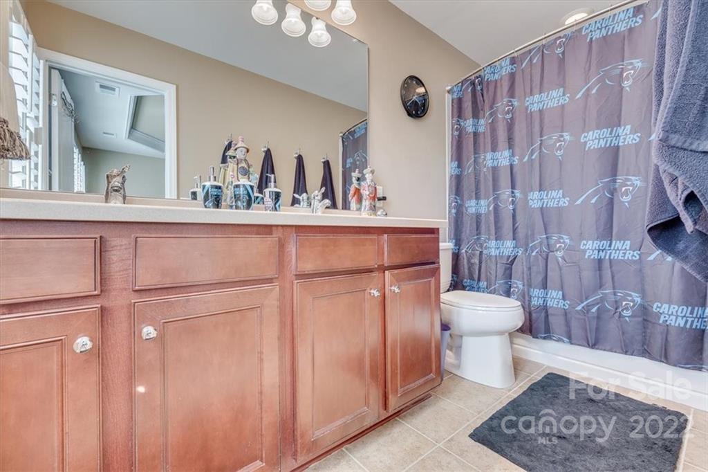 1112 Drayton Court Fort Mill, SC 29708 - Photo 20 of 27 a bathroom with a toilet a sink and a shower curtain
