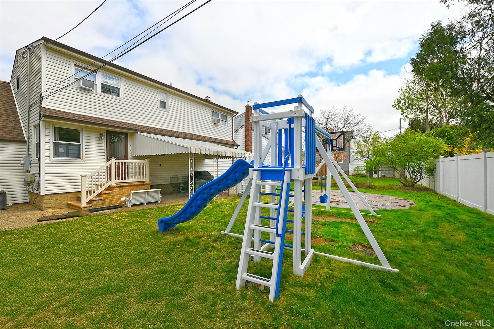 25 Lincoln Road North Plainview, NY 11803 - Photo 4 of 13 a view of a house with a backyard and a slide