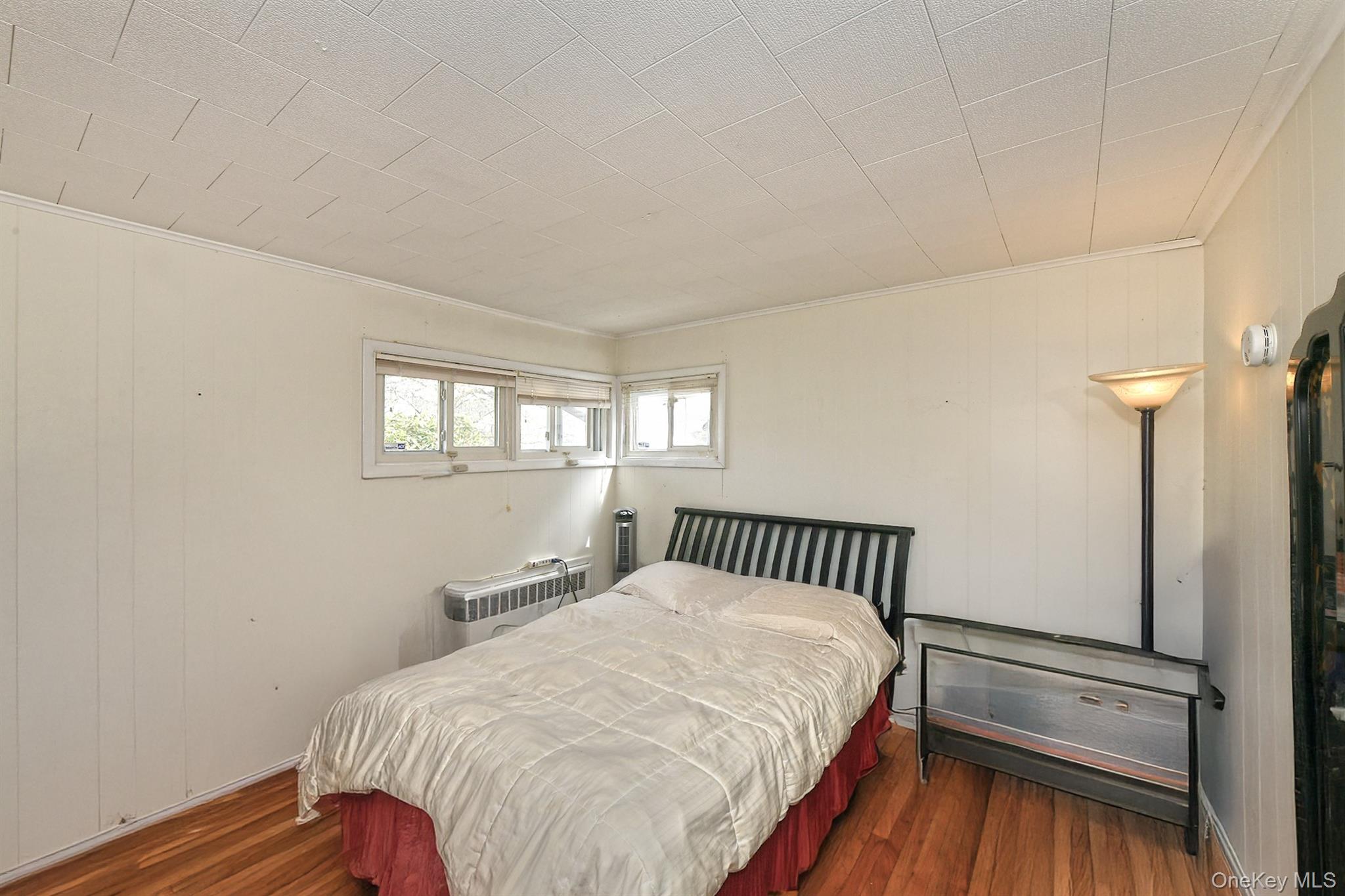 25 Lincoln Road North Plainview, NY 11803 - Photo 6 of 13 a bedroom with a bed and window