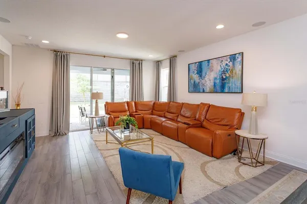 a living room with furniture and wooden floor