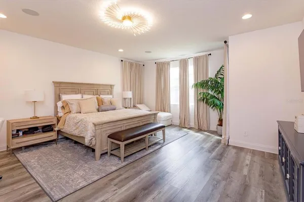a bedroom with a bed and a potted plant
