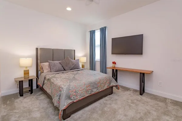 a bedroom with a bed and a flat screen tv