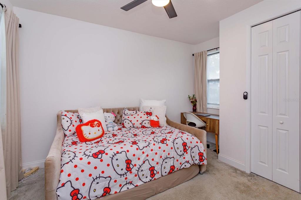 1231 Foltz Loop Oakland, FL 34787 - Photo 21 of 30 a bedroom with a bed and a chandelier