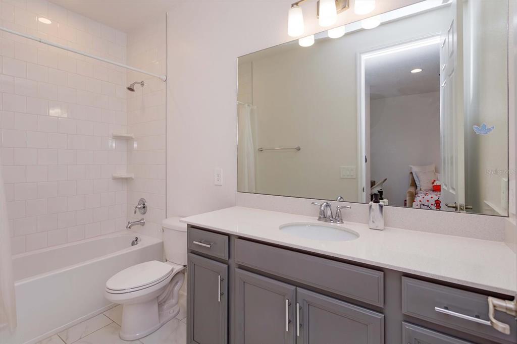 1231 Foltz Loop Oakland, FL 34787 - Photo 22 of 30 a bathroom with a sink a toilet and shower