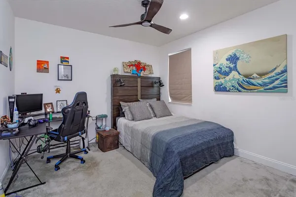 a bedroom with a bed a desk and chair