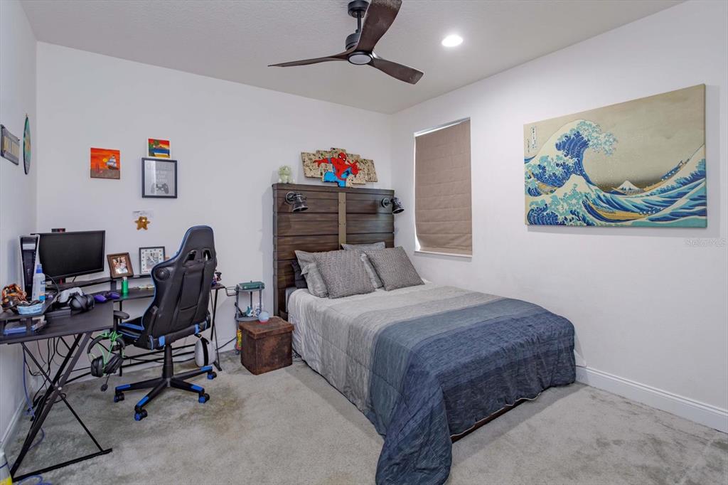 1231 Foltz Loop Oakland, FL 34787 - Photo 23 of 30 a bedroom with a bed a desk and chair