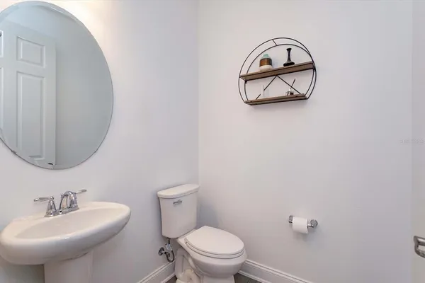 a bathroom with a sink mirror and toilet