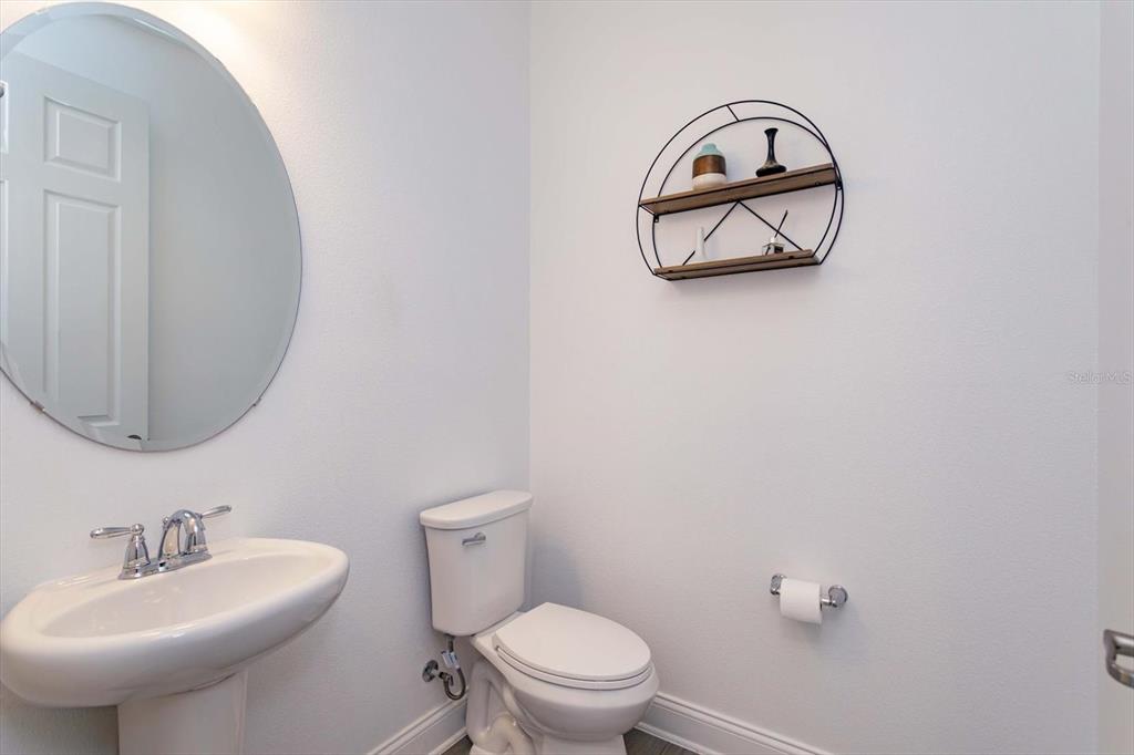 1231 Foltz Loop Oakland, FL 34787 - Photo 24 of 30 a bathroom with a sink mirror and toilet