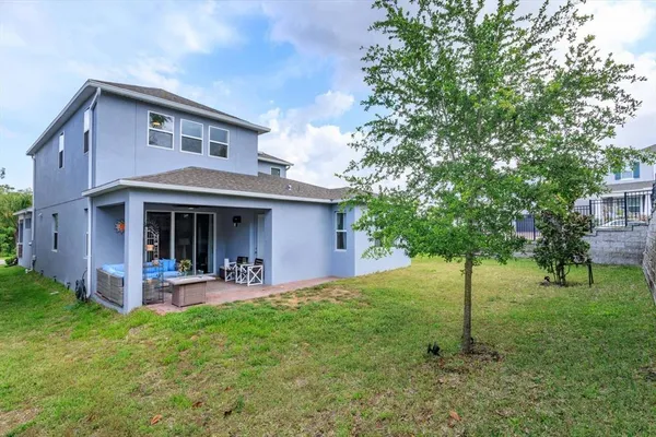 a view of a house with a yard and sitting area