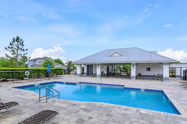 a swimming pool with outdoor seating yard and barbeque oven