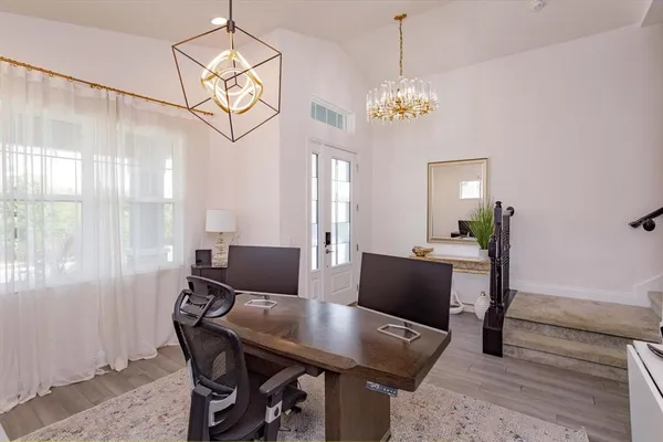 a view of a dining room with furniture and chandelier