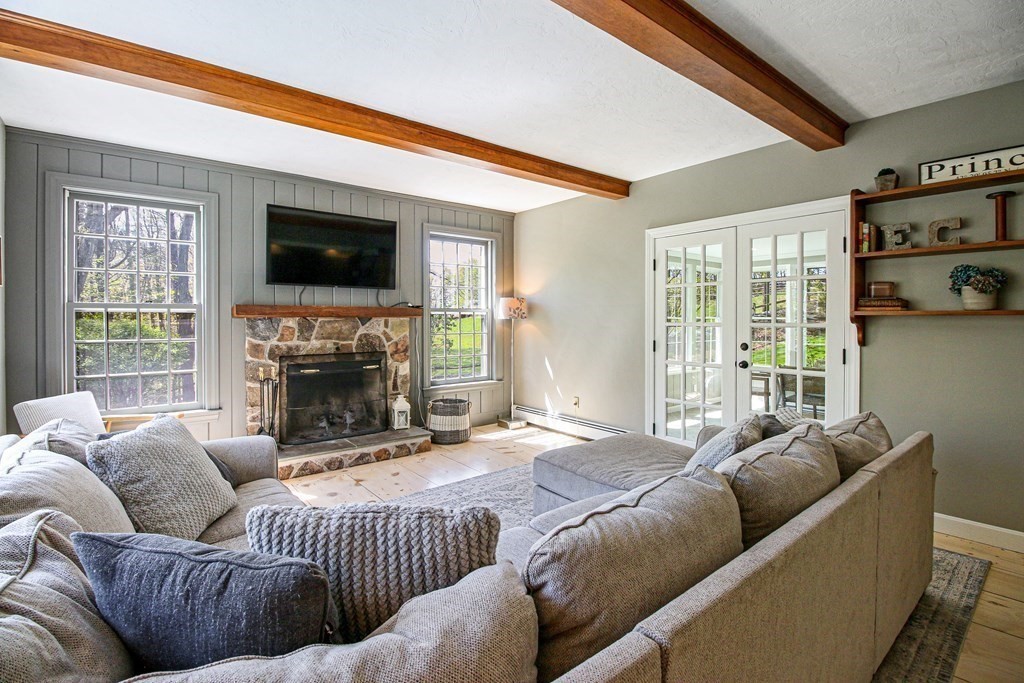 235 Mirick Road Princeton, MA 01541 - Photo 8 of 42 a living room with furniture a flat screen tv and a fireplace