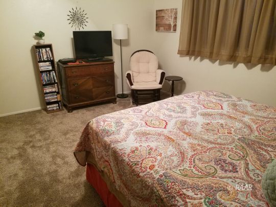 509 Randall Street Ridgecrest, CA 93555 - Photo 21 of 32 a bedroom with a bed and a flat screen tv